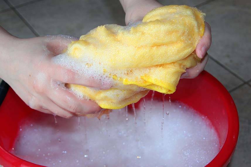 Rinsing Wet Cloth into Bucket